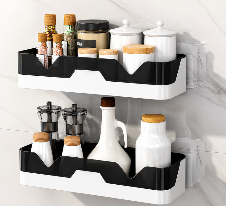 Two-tier wall-mounted spice and condiment organizers in black and white, shown holding jars, bottles, and containers against a light marble wall.